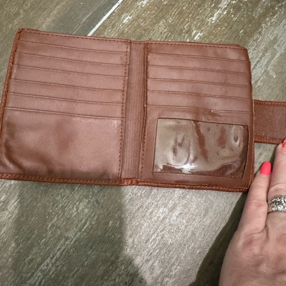 Vintage Brown Leather Wallet with Snap Closure and Embossed Emblem